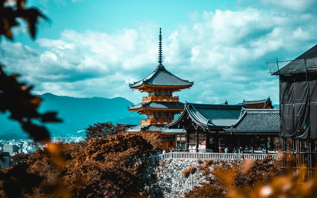 The three-storey pagoda of Kiyomizu-dera rising above autumn maples on the hills of Kyoto